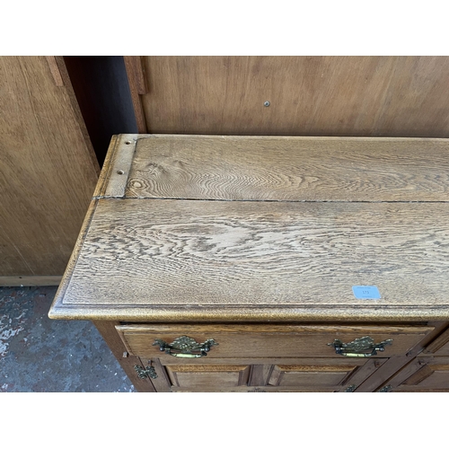 173 - An Arts & Crafts style panelled oak sideboard