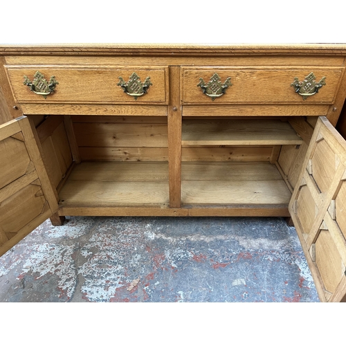 173 - An Arts & Crafts style panelled oak sideboard