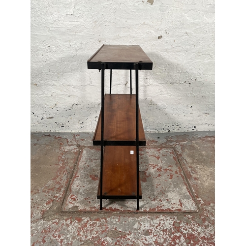 179 - A 1960s teak and black metal three tier shelving unit - approx. 76cm high x 64cm wide x 23cm deep