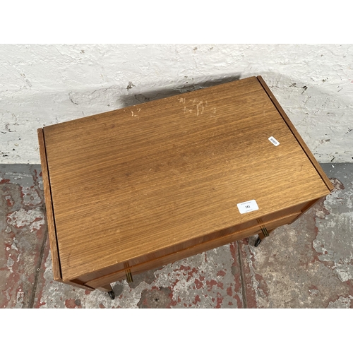 181 - A mid 20th century teak sewing table containing sewing accessories