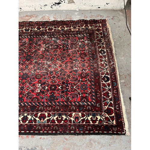 201 - A hand knotted Persian rug - approx. 315cm x 127cm