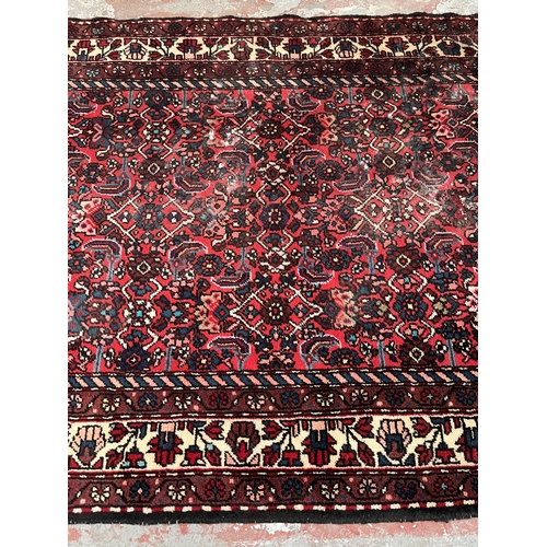 201 - A hand knotted Persian rug - approx. 315cm x 127cm