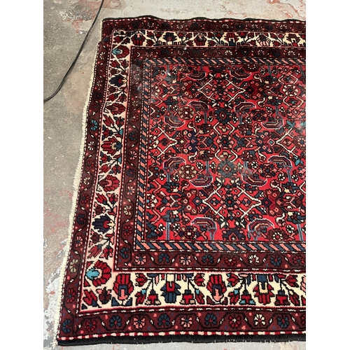 201 - A hand knotted Persian rug - approx. 315cm x 127cm