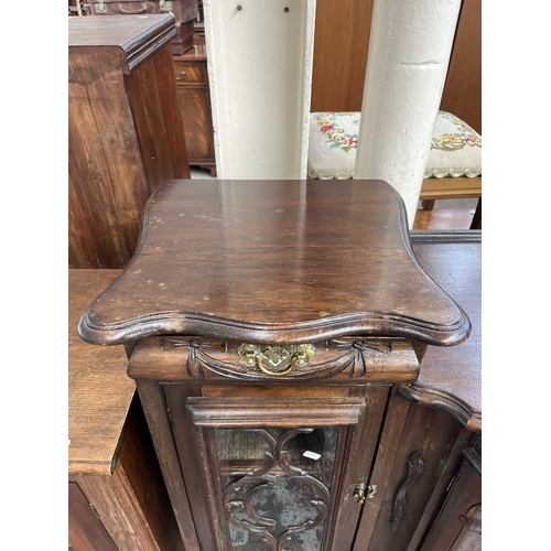 214 - A late 19th/early 20th century mahogany bow fronted glazed sideboard