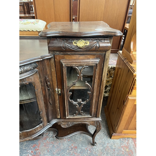 214 - A late 19th/early 20th century mahogany bow fronted glazed sideboard