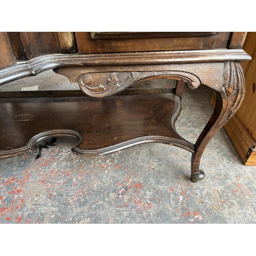 214 - A late 19th/early 20th century mahogany bow fronted glazed sideboard