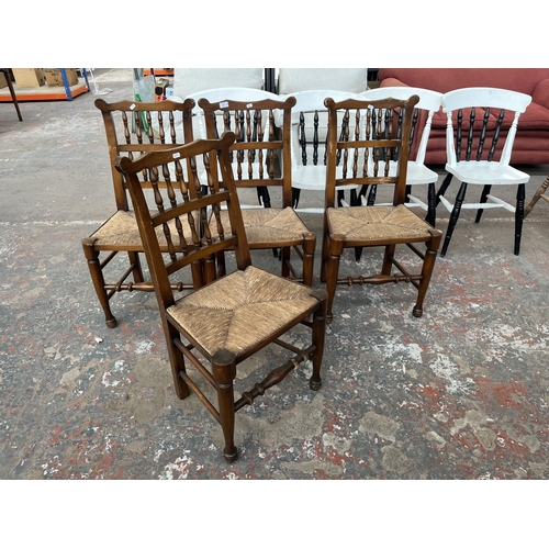 225 - Four 19th century style beech spindle back Lancashire dining chairs with rush seats