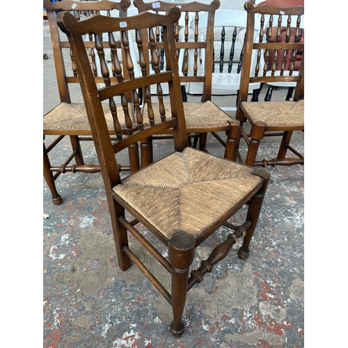 225 - Four 19th century style beech spindle back Lancashire dining chairs with rush seats