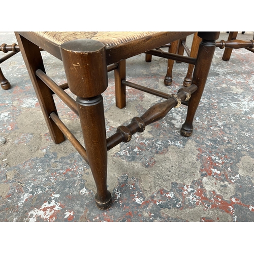 225 - Four 19th century style beech spindle back Lancashire dining chairs with rush seats