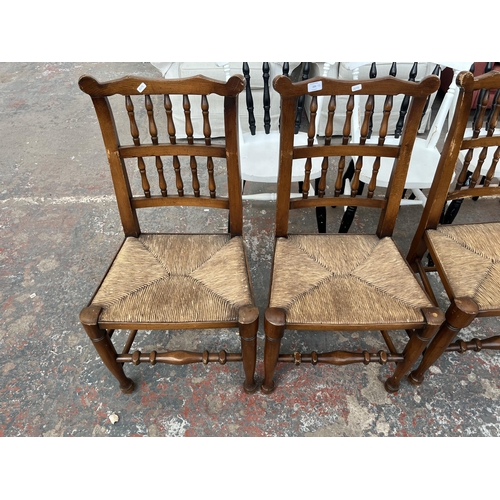 225 - Four 19th century style beech spindle back Lancashire dining chairs with rush seats