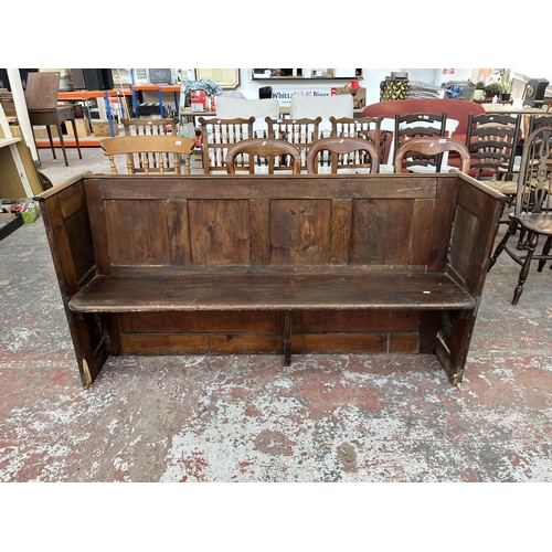 230 - An early 20th century pine church pew - approx. 85cm high x 165cm wide x 50cm deep