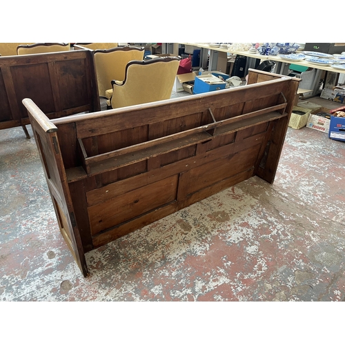 230 - An early 20th century pine church pew - approx. 85cm high x 165cm wide x 50cm deep