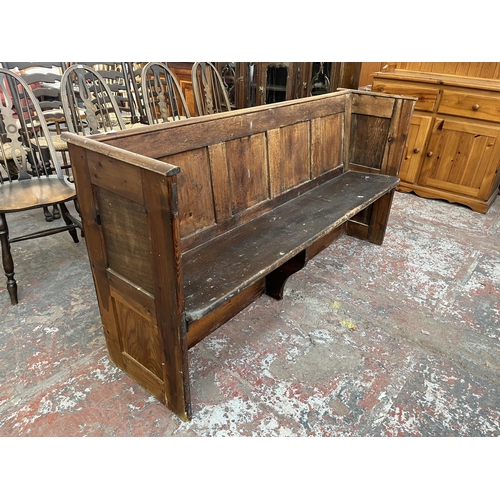 231 - An early 20th century pine church pew - approx. 85cm high x 164cm wide x 47cm deep