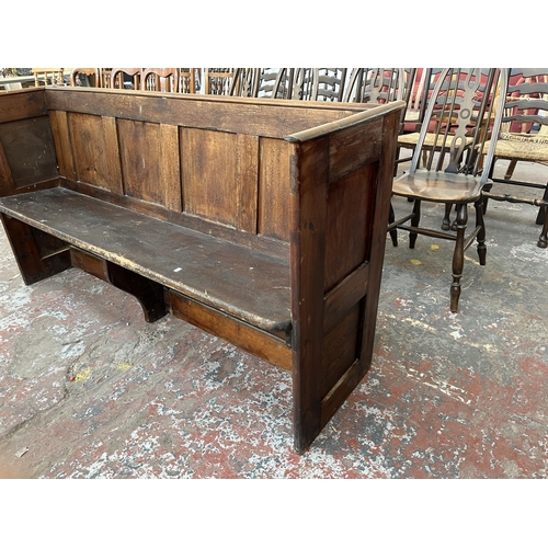 231 - An early 20th century pine church pew - approx. 85cm high x 164cm wide x 47cm deep