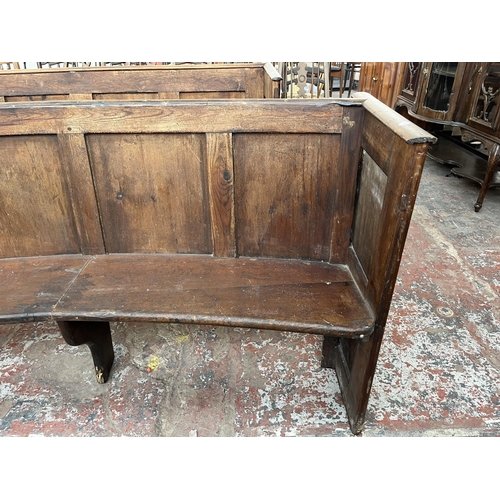 232 - An early 20th century pine curved church pew - approx. 85cm high x 165cm wide x 45cm deep