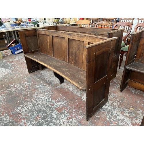 233 - An early 20th century pine curved church pew - approx. 85cm high x 164cm wide x 46cm deep