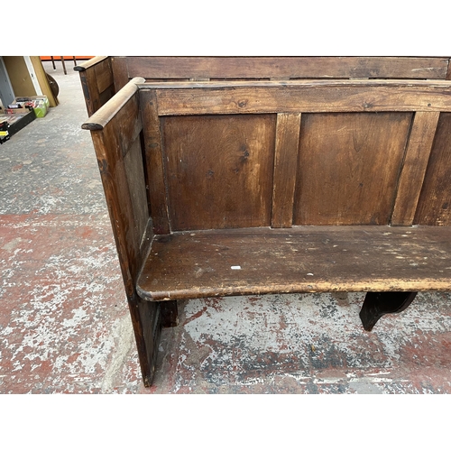 233 - An early 20th century pine curved church pew - approx. 85cm high x 164cm wide x 46cm deep