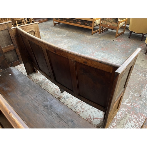 233 - An early 20th century pine curved church pew - approx. 85cm high x 164cm wide x 46cm deep