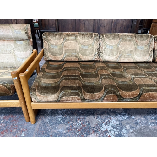 234 - A mid 20th century beech and fabric upholstered two piece lounge suite comprising three seater sofa ... 