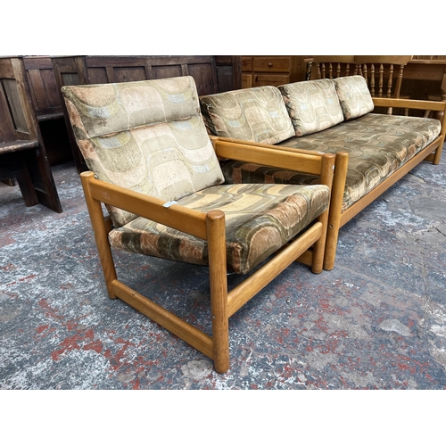 234 - A mid 20th century beech and fabric upholstered two piece lounge suite comprising three seater sofa ... 