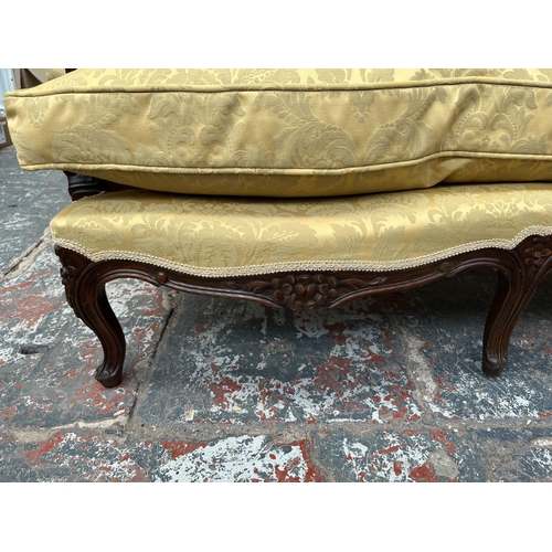 237 - A Victorian style carved mahogany and floral upholstered parlour sofa