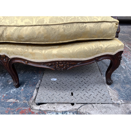 237 - A Victorian style carved mahogany and floral upholstered parlour sofa