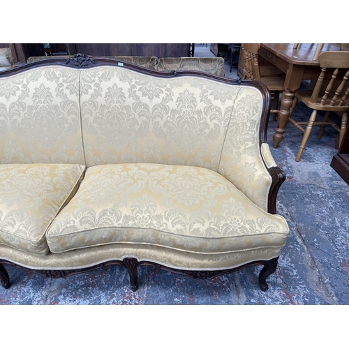 238 - A Victorian style carved mahogany and floral upholstered parlour sofa