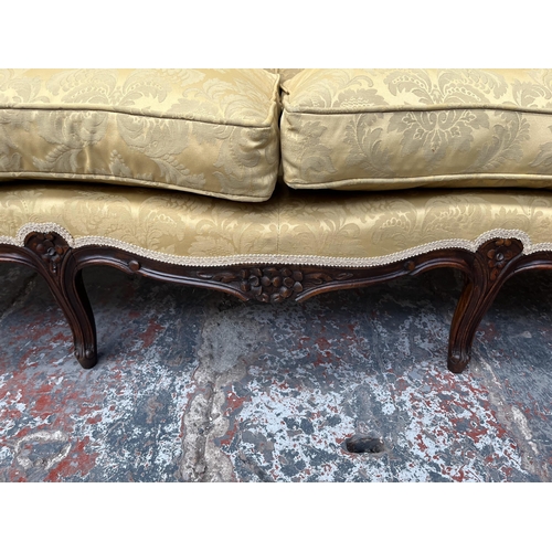 238 - A Victorian style carved mahogany and floral upholstered parlour sofa