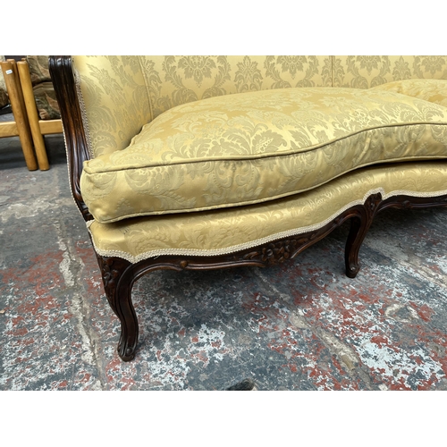 238 - A Victorian style carved mahogany and floral upholstered parlour sofa