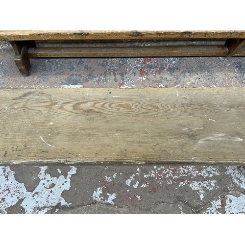 241 - An early 20th century pitch pine bench - approx. 46cm high x 27cm wide x 376cm long