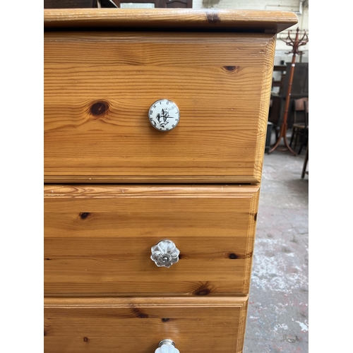 116 - A pine effect chest of five drawers