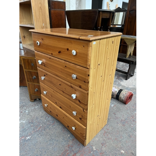 116 - A pine effect chest of five drawers