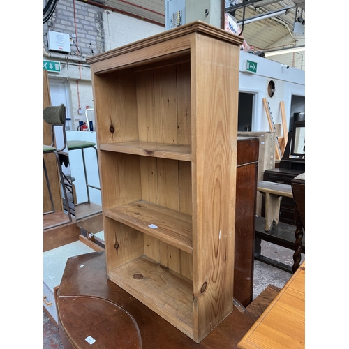 117 - A pine three tier bookcase - approx. 101cm high x 61cm wide x 23cm deep