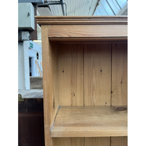 117 - A pine three tier bookcase - approx. 101cm high x 61cm wide x 23cm deep