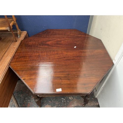 124 - A late 19th/early 20th century walnut octagonal centre table with galleried X frame stretcher - appr... 