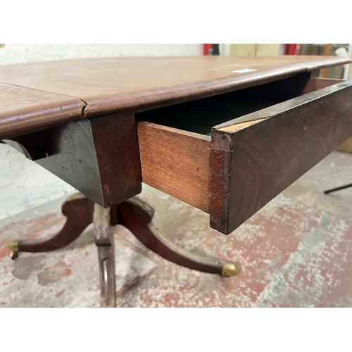 125 - A 19th century mahogany drop leaf pedestal Pembroke table