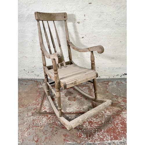 129 - A 19th century elm spindle back farmhouse rocking chair