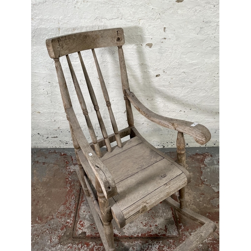 129 - A 19th century elm spindle back farmhouse rocking chair