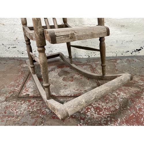 129 - A 19th century elm spindle back farmhouse rocking chair