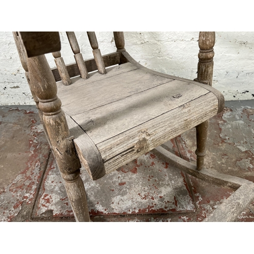 129 - A 19th century elm spindle back farmhouse rocking chair