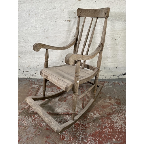 129 - A 19th century elm spindle back farmhouse rocking chair