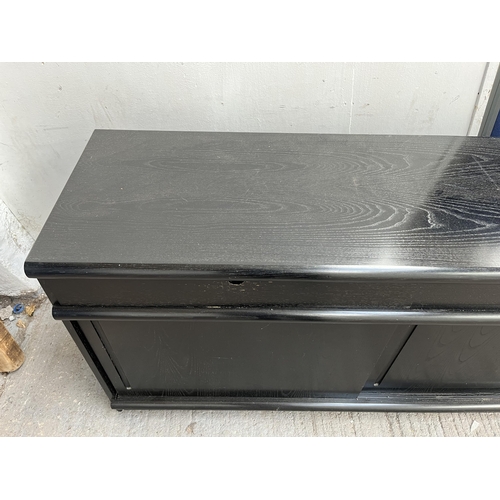 131 - A modern black ash effect sideboard - approx. 71cm high x 210cm wide x 45cm deep