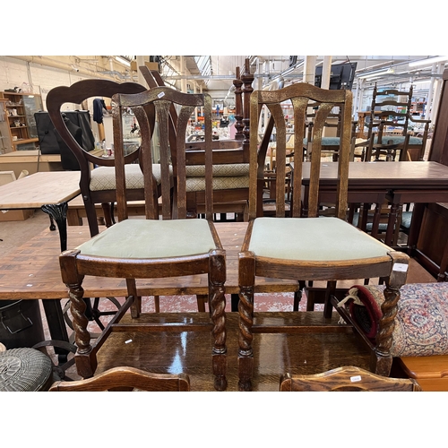 146 - An oak drop leaf gate leg oval dining table on barley twist supports and four dining chairs