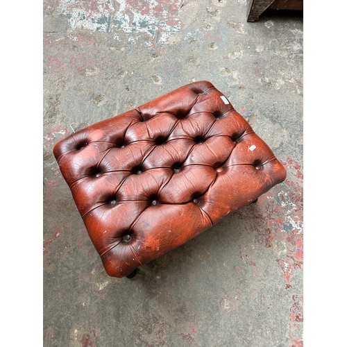 55 - An ox blood red leather Chesterfield footstool on cabriole supports