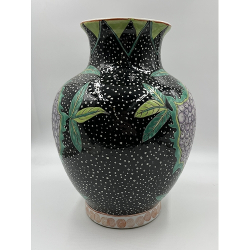 288 - A Chinese hand painted porcelain vase depicting berries and leaves - approx. 30cm high