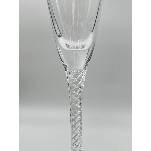 313 - A pair of Stuart twisted stem champagne flutes - approx. 32cm high