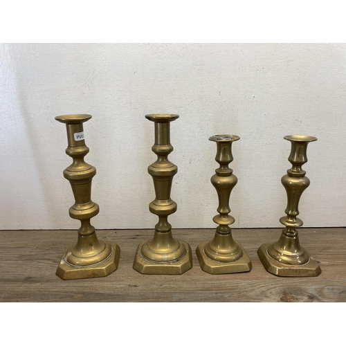 370 - Eight pieces of antique metalware to include two pairs of brass candlesticks, two copper and brass k... 