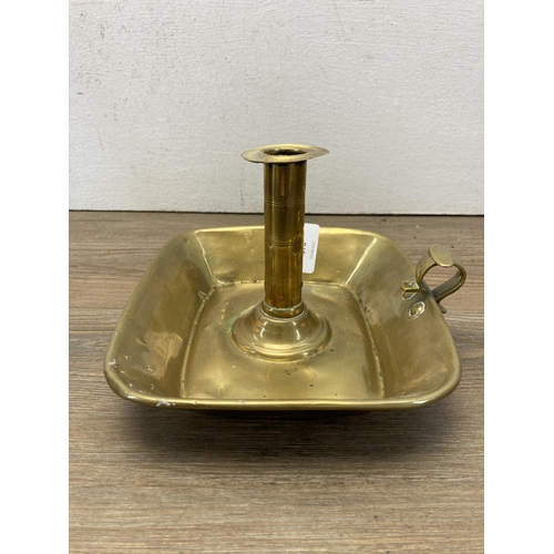 378 - Three 19th century and later pieces of metalware, one brass chamberstick, one brass trivet stand and... 