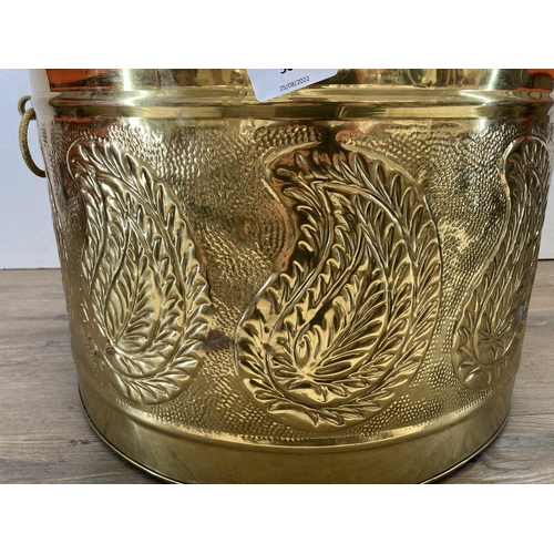 381 - An embossed and hammered brass log bucket - approx. 29cm high x 43cm diameter