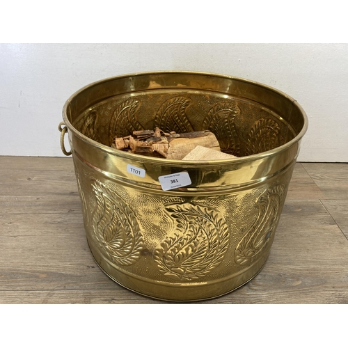 381 - An embossed and hammered brass log bucket - approx. 29cm high x 43cm diameter